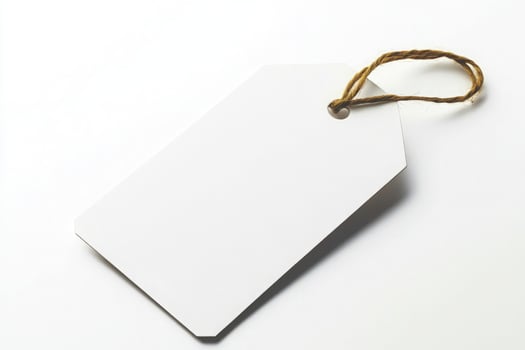 Blank white paper tag with twine, isolated on white background photo