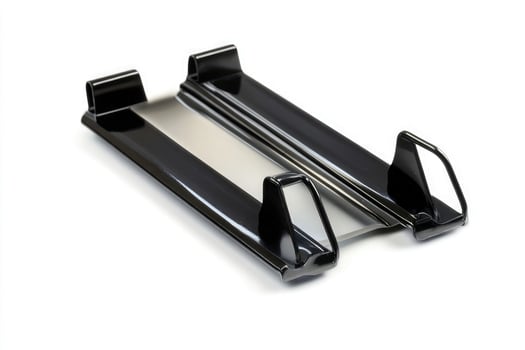 Two black metal components with silver accents, isolated on a white background photo
