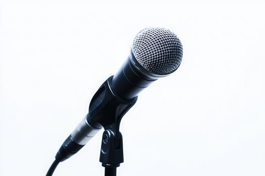 Silver and black microphone on a stand isolated on white background photo