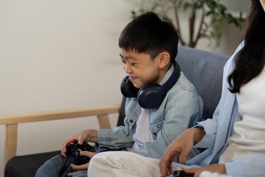 Exciting Gaming Session. Child and Mother Engaged in Play photo