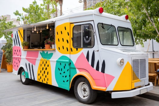 Colorful food truck parked on a city street offering delicious meals photo