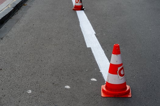 A street with orange and white traffic cones photo