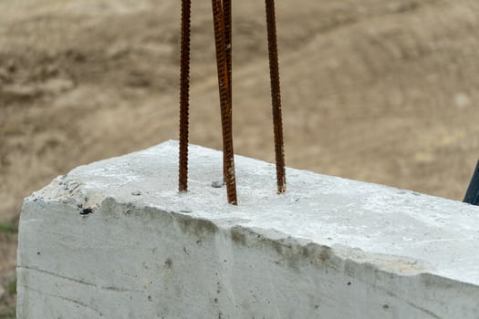A man is standing on a concrete block with a hammer photo