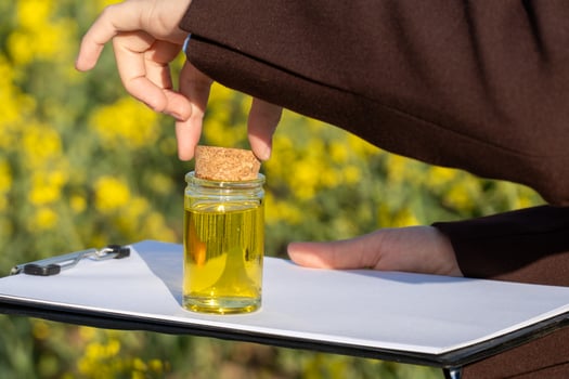 A person holding a bottle of oil photo
