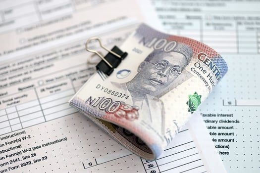 Nigerian naira money on tax form. Taxation concept photo