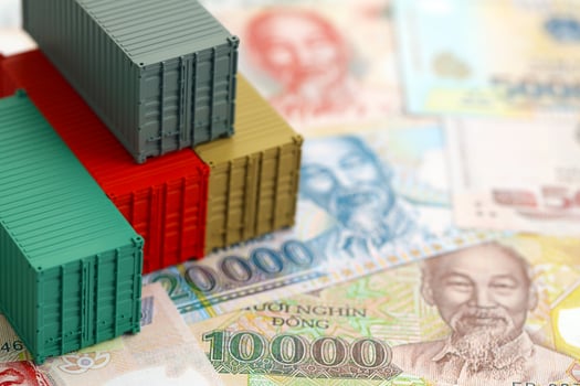 Vietnamese dong currency money bills and toy cargo containers. The concept of shipping and logistics photo