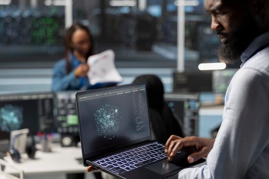 Data center admin using artificial intelligence visualization tools on laptop to identify equipment errors. Server hub worker looking at insights on notebook to detect hardware failures photo