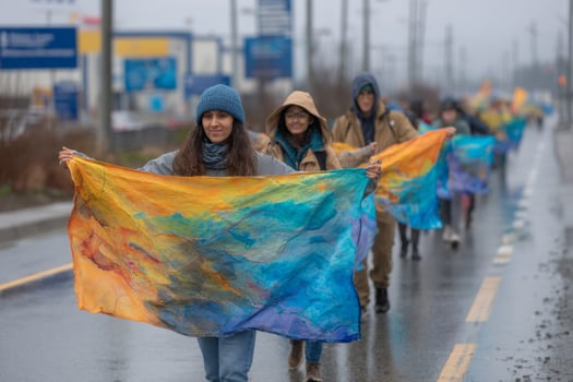 A group of people walking down the street holding colorful flags photo