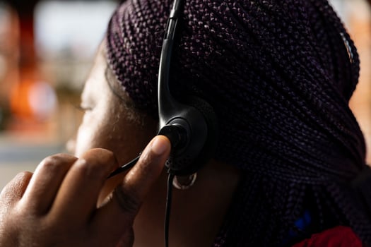 Call center agent using headset to talk with customer, adhering to company provided communication guidelines. Close up of customer support worker following call script while speaking with client photo
