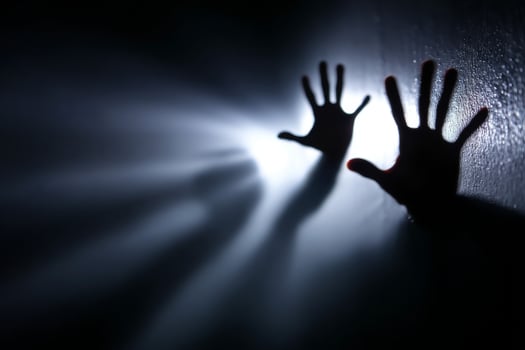 Hands reaching out from a dark room photo