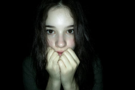 A young girl with her hands on her face photo