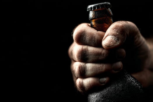 A man's hand holding a beer bottle photo