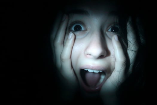 A woman is looking into the camera with her mouth open photo