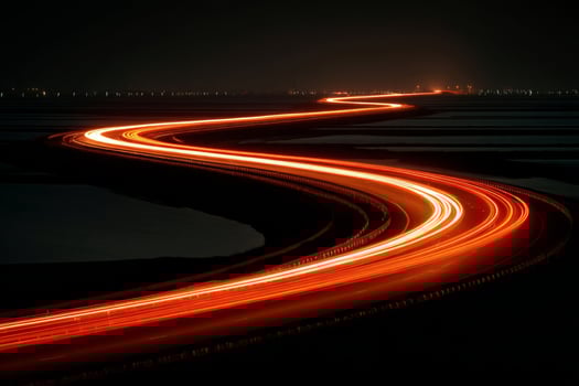 A long exposure photograph of a highway at night photo