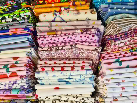 Colorful stacks of patterned fabric inspiring creativity in textile design photo