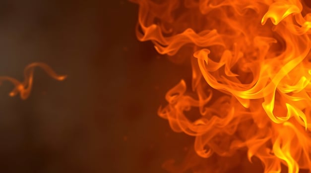 A close up of a fire with flames and smoke on black background. photo