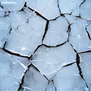 Intricate cracked ice floes on a dark background photo