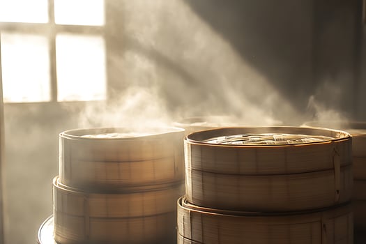 Steaming Bamboo Baskets Fill the Air with Delicious Aroma and Warm Light. photo
