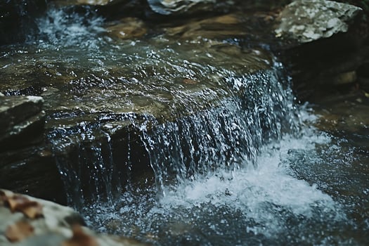 Tranquil Forest Waterfall Cascading Over Rocks in Gentle Flow. photo