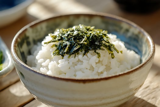 Steaming Bowl of Japanese Rice with Crispy Seaweed Topping. photo