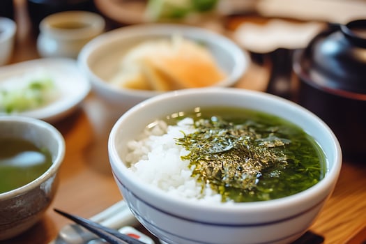 Delicious Japanese Meal with Rice, Tea, and Seaweed. photo