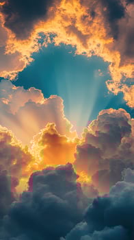 Golden sunlight dramatically streams through thick, gray storm clouds, illuminating the celestial sky beautifully photo