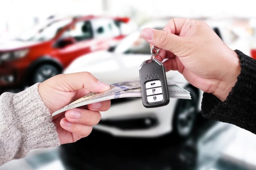 Car buying deal with cash and key exchange, symbolizing vehicle purchase or auto ownership transfer. photo