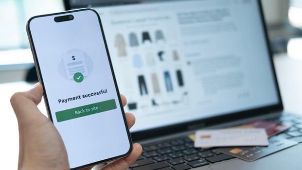 Holding a phone with payment success displayed, and a credit card placed below, highlighting the convenience of cashless payment systems used anywhere photo