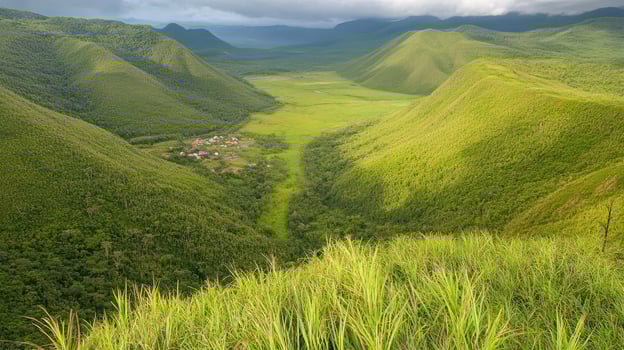 Scenic view of lush green valley with distant village nestled among rolling hills and mountains photo