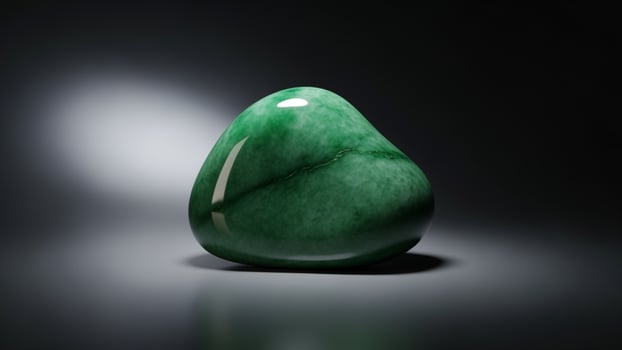A green stone is sitting on a table photo