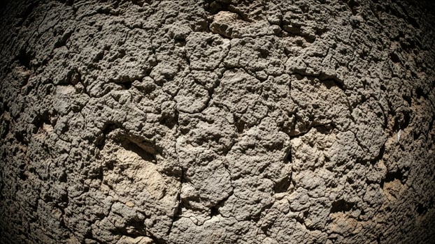 A close up of a rock wall with dirt and dirt photo