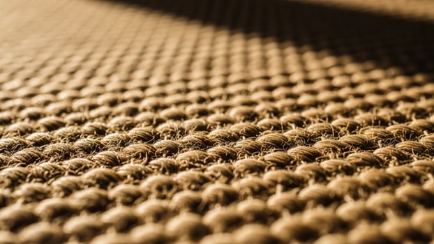 A close up of a carpet with a lot of small holes photo