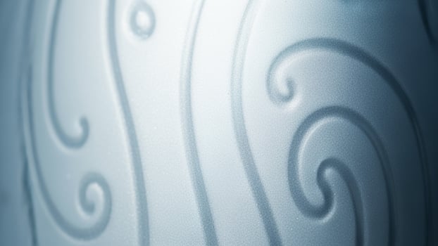 A close up of a white vase with swirls photo