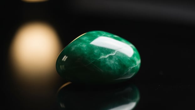 A green stone sitting on a table photo