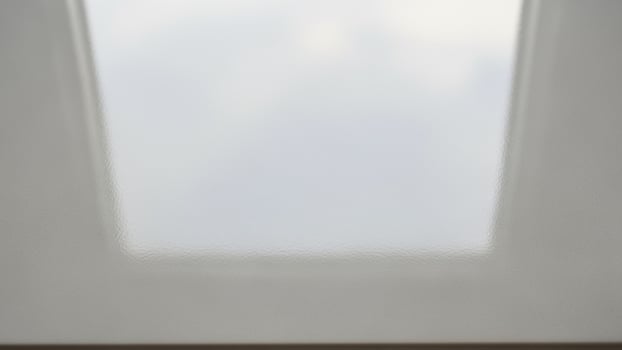 A white window with a view of the sky photo