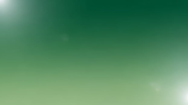 A blurry green background with a blurry white object photo
