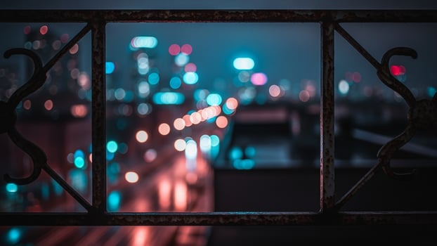 A view of the city at night from a balcony photo