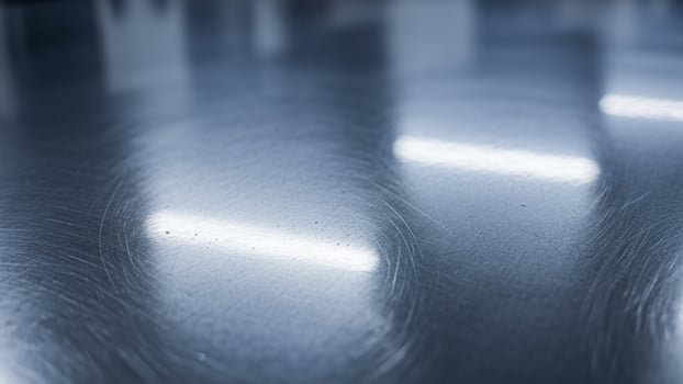 A shiny metal surface with a light shining on it photo