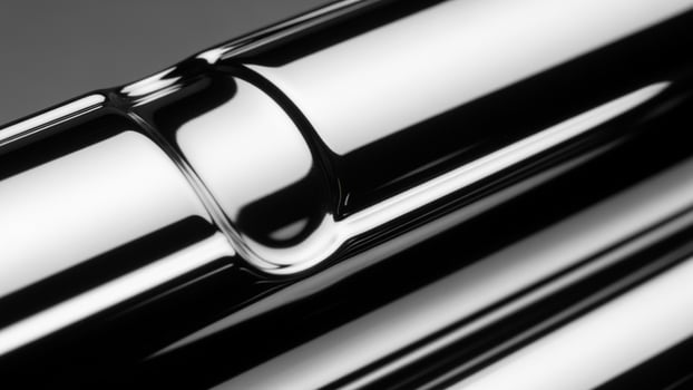 A close up of a metal pipe with a black background photo