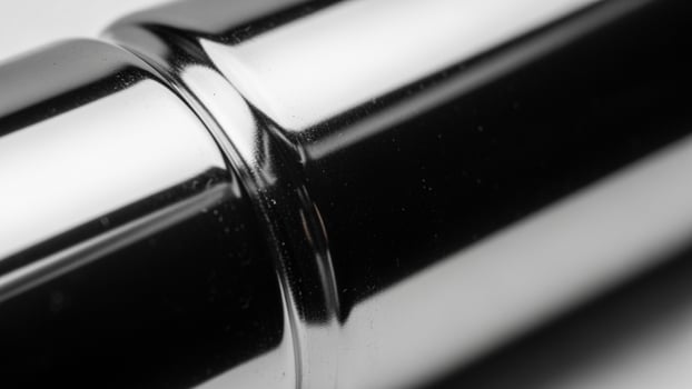 A close up of a chrome tube with a black background photo