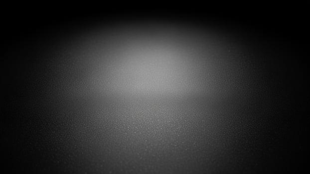 Black and white photo of a dark room with a spotlight