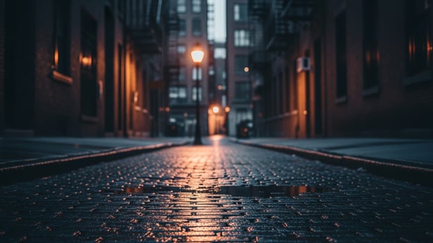 A street with a light shining on it at night photo