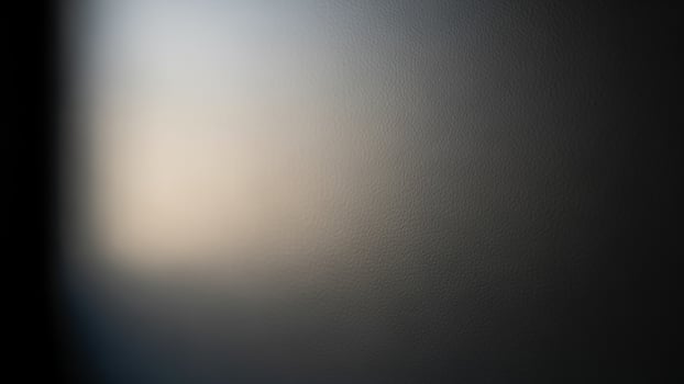 A blurry photo of a window with a light coming through