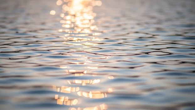 Sunlight shining through water on a lake photo