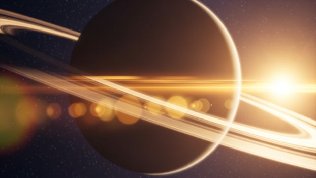 Saturn with rings and sun in the background photo