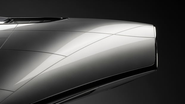 The front end of a silver sports car photo