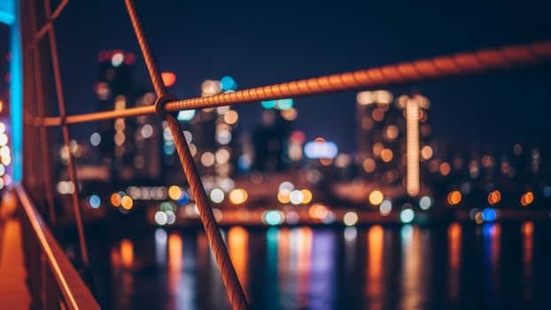 City lights at night on a bridge over water photo