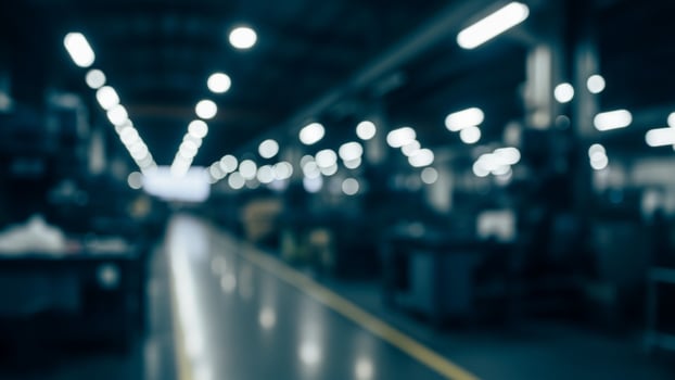 A blurry image of a factory with lights on photo