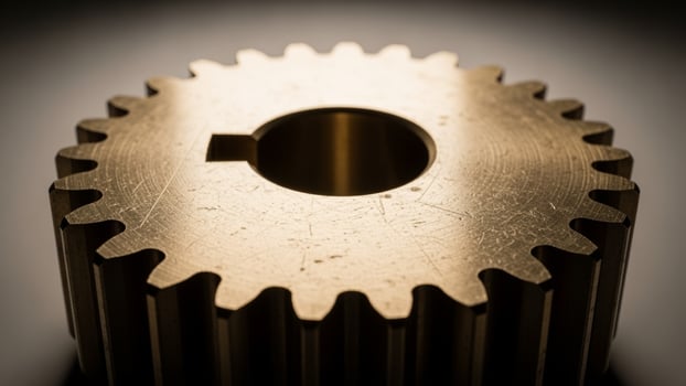 A close up of a metal gear on a black background photo