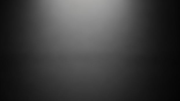 Black and white photo of a spotlight on a dark background